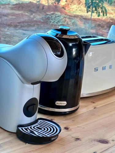 a coffee maker sitting on top of a table at Tiny Escape Charlotte in Pak Chong