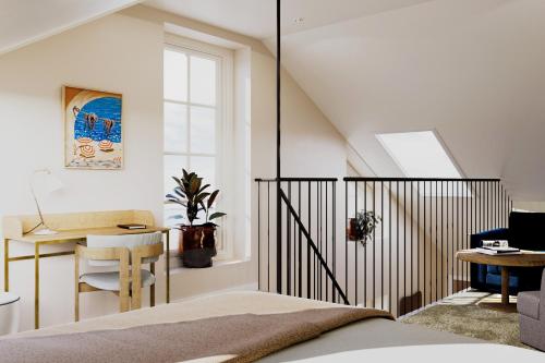 a bedroom with a bed and a desk and a chair at Kusthotellet Styrsö in Styrsö