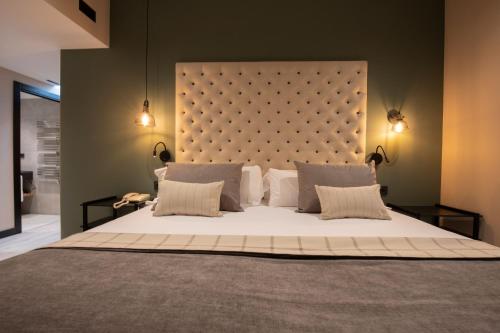 a bedroom with a large bed with a large headboard at Hotel Piolets Soldeu Centre by Nexta in Soldeu