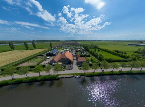 an aerial view of a resort next to a river at Buitenplaats Medemblik in Medemblik