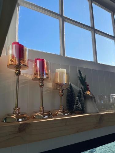 a counter with three candles and christmas trees on it at Tiny Escape Charlotte in Pak Chong