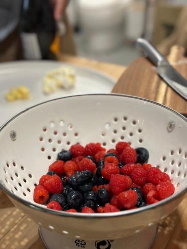 a strainer filled with berries on top of a table at Tiny Escape Charlotte in Pak Chong