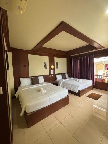 a hotel room with two beds and a window at Rin Bay View Resort in Haad Rin
