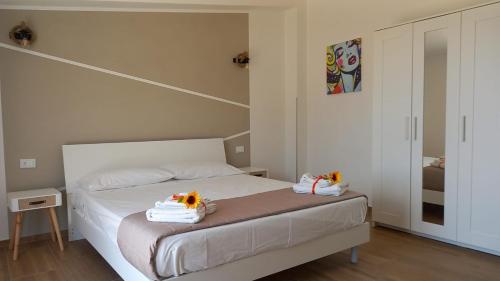 a bedroom with a bed with towels on it at Villa Saint George in Scopello