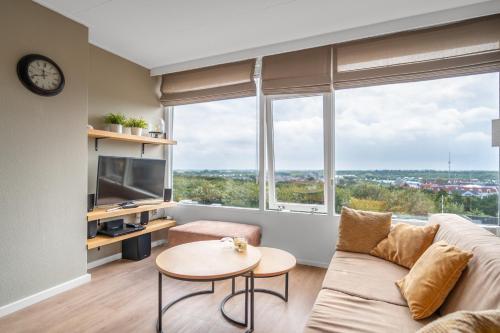 a living room with a couch and a table at Appartementencomplex Juliana 178 in De Koog