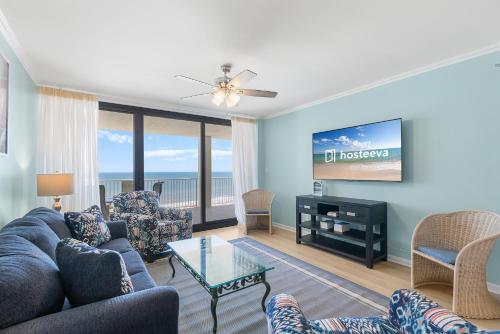 a living room with a couch and a tv at Windward Pointe Condominiums in Orange Beach