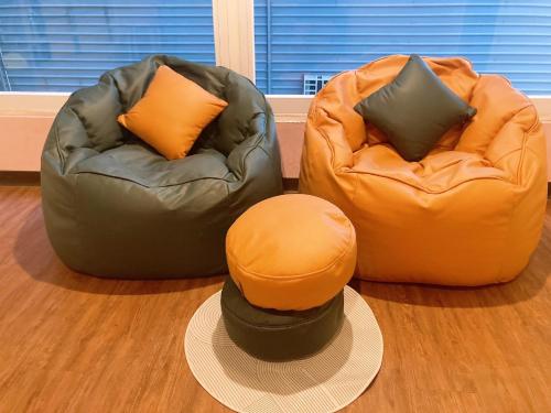 two bean bag chairs sitting on the floor with a hat at LIKE Hostel & Bar Lounge in Kaohsiung