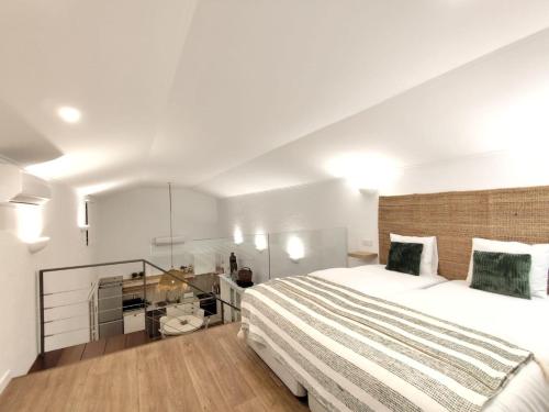 a bedroom with a large bed and a desk at Monte de São Francisco Country House in Vale de Maceira