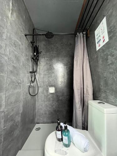 a bathroom with a sink and a toilet and a shower at Industrial Luxe Concrete Bliss, near Sunway Pyramid,Subang Jaya in Subang Jaya