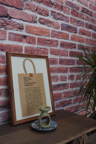 a picture on a table next to a brick wall at Industrial Luxe Concrete Bliss, near Sunway Pyramid,Subang Jaya in Subang Jaya