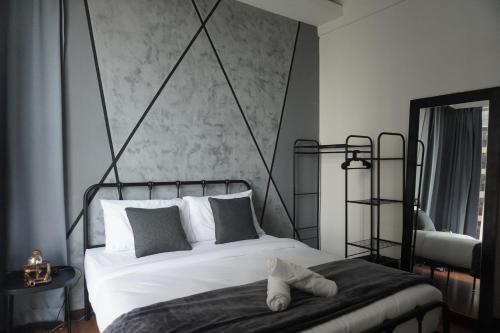 a bedroom with a white bed with a black frame at Industrial Luxe Concrete Bliss, near Sunway Pyramid,Subang Jaya in Subang Jaya
