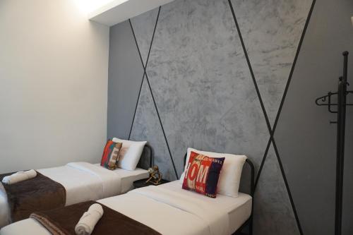 a room with two beds and a couch in it at Industrial Luxe Concrete Bliss, near Sunway Pyramid,Subang Jaya in Subang Jaya