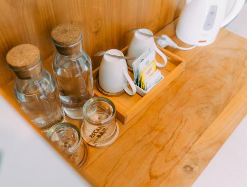 a wooden shelf with bottles and jars on a table at Escape Bajo in Labuan Bajo