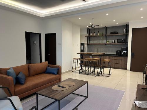 a living room with a couch and a table at Industrial Luxe Concrete Bliss, near Sunway Pyramid,Subang Jaya in Subang Jaya