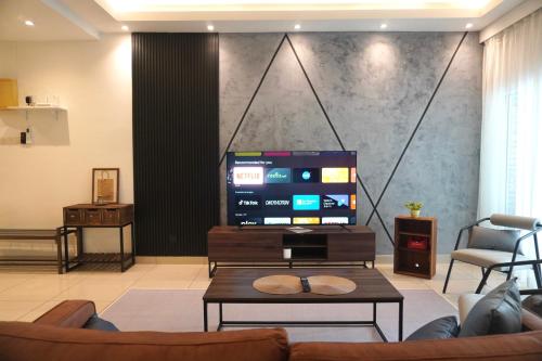 a living room with a tv and a couch and a table at Industrial Luxe Concrete Bliss, near Sunway Pyramid,Subang Jaya in Subang Jaya