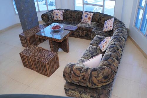 a living room with a couch and a table at Hotel Chail Hill & Restaurant in Chachyot