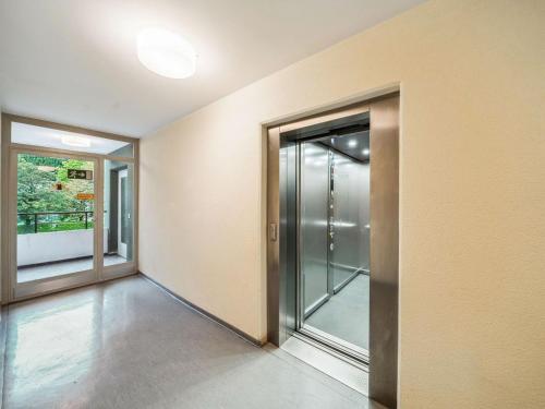 an empty hallway with glass doors in a house at GMA Apartment B16 in Lahr