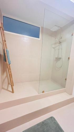 a shower with a glass door in a bathroom at Villa Bleue Agadir climatisée-centre-3chambres in Agadir