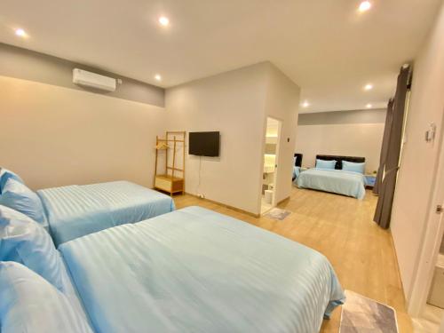 a hospital room with two beds and a flat screen tv at Luxor Villa Private Pool in Ngaglik