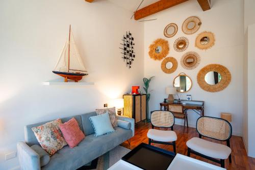 a living room with a blue couch and chairs at Club del Sole Tenuta Primero Grado Family Collection in Grado