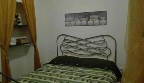a bed in a room with a picture on the wall at B&B River in Ascoli Piceno