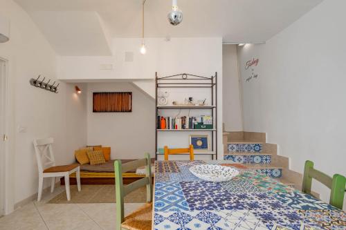 a room with a bed and a table and a couch at Antiche Mura Apartments"Cielo di Puglia" -2 matrimoniali, cucina e terrazzo in Turi