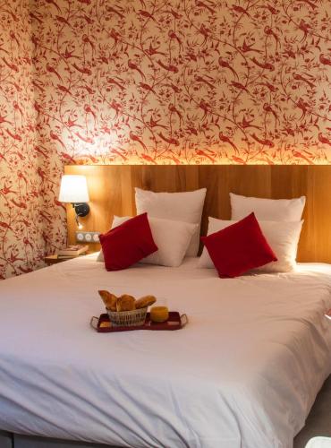 a bed with a tray of food on top of it at Château de Roques in Teilhet