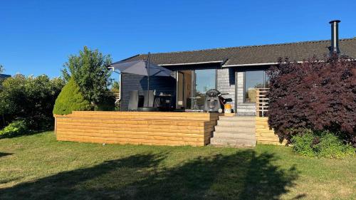 a house with a wooden fence in the yard at Holidayhome Near The Water in Karrebæksminde