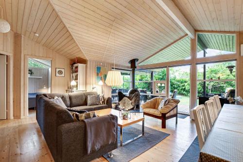a living room with two couches and a table at Family Summer House In Quiet Area in Græsted