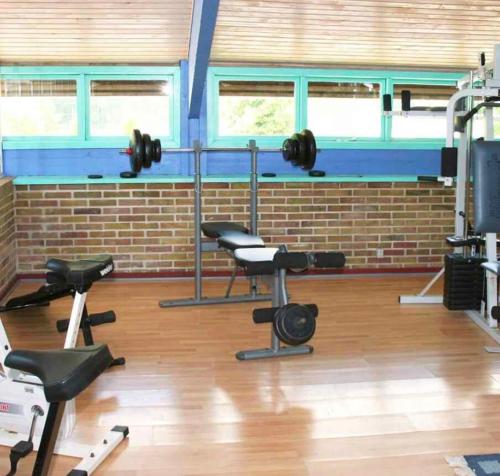 a gym with dumbbells and weights in a room at Newly Renovated Holiday Apartment On Bornholm in Neksø