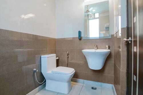 a bathroom with a toilet and a sink at Hotel Leaf 9, Cyber City near Ambience Mall in Gurgaon