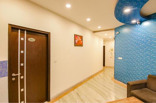 a room with a door and a blue wall at Hotel Leaf 9, Cyber City near Ambience Mall in Gurgaon