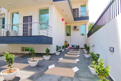 an empty courtyard with potted plants in a building at Hotel Leaf 9, Cyber City near Ambience Mall in Gurgaon