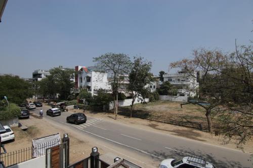 a city street with cars parked on the side of the road at Hotel Leaf 9, Cyber City near Ambience Mall in Gurgaon