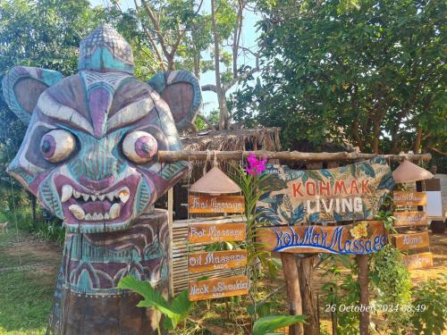a statue of a elephant standing next to signs at Koh Mak Living in Ko Mak