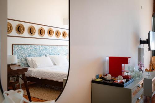 a bedroom with a bed and a mirror at Club del Sole Tenuta Primero Grado Family Collection in Grado