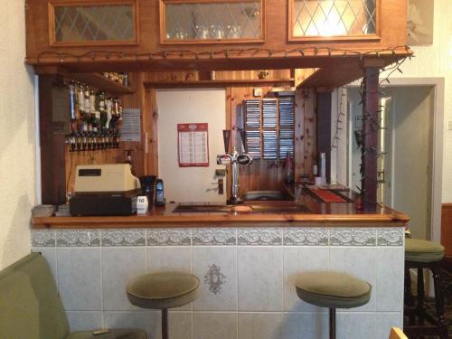 a bar with two stools in front of it at Bel Reve Hotel in Blackpool