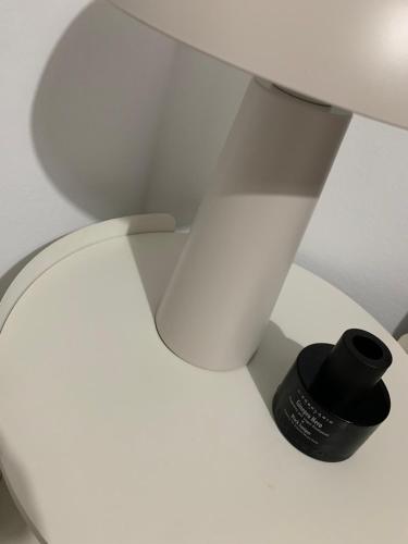 a white toilet with a black bottle on it at Aelin Living in Agrinion