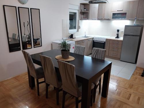 a kitchen with a dining room table and chairs at Sorin Apartments Gevgelija in Gevgelija