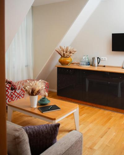 a living room with a couch and a table at Hotel Altes Fährhaus in Berlin