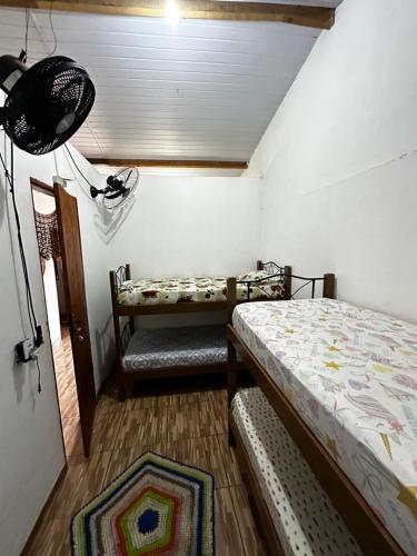 a bedroom with a bed and a bench in a room at Casa da praia Atins Maranhão in Atins