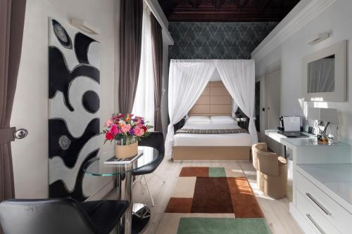 a bedroom with a bed and a table in a room at LHP Hotel River & SPA in Florence