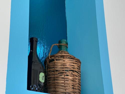 two bottles of wine sitting next to each other at Pompei Sunday Estate Exclusive Apartaments in Pompei