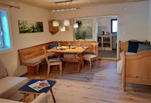 a living room with a table and a dining room at Naturetouch in Steinberg am Rofan