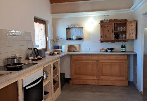 a kitchen with wooden cabinets and a counter top at Naturetouch in Steinberg am Rofan