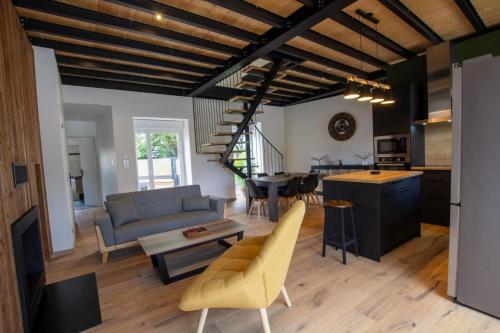 a living room with a couch and a table at Gite de la fontanelle in Anlhiac