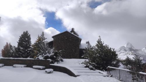 a house with snow on the ground in front of it at Abuela Carmen in Riaño