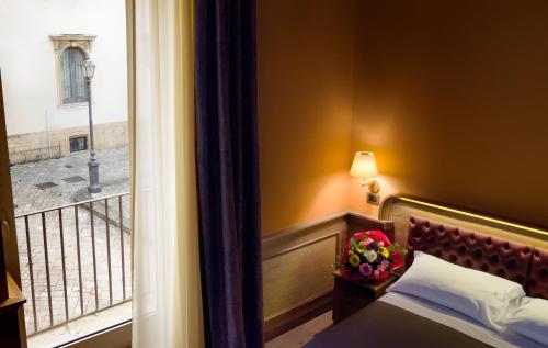 a hotel room with a bed and a balcony at Le Club Boutique Hotel in Lecce