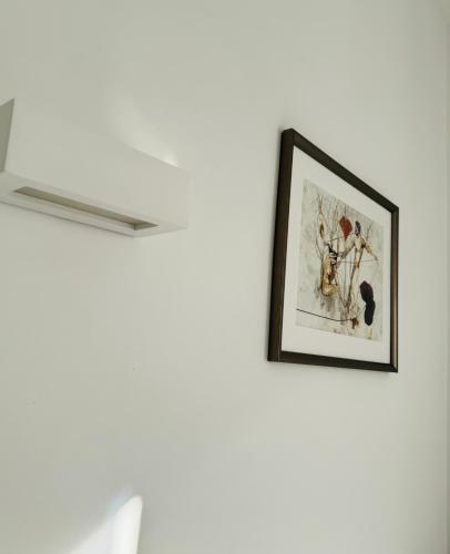 a picture hanging on a wall in a room at Fil Rouge in Ciampino