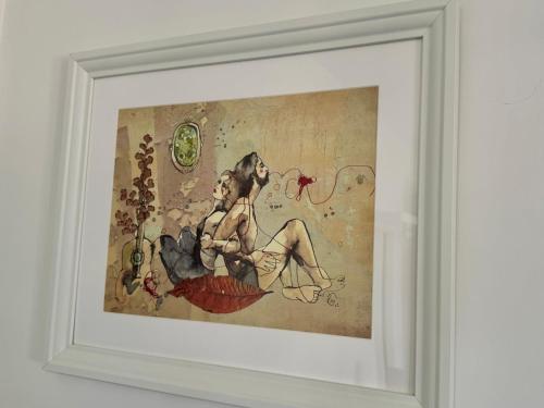 a painting of two women sitting on a wall at Fil Rouge in Ciampino